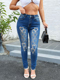 Heart embroidery rhinestone skinny jeans for women – front view of stretchy sexy sparkly blue denim pants on model