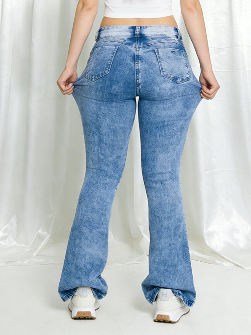 Styled classic blue ripped bootcut jeans for women – stretch sexy butt lifting denim pants with fitted top and boots outfit look