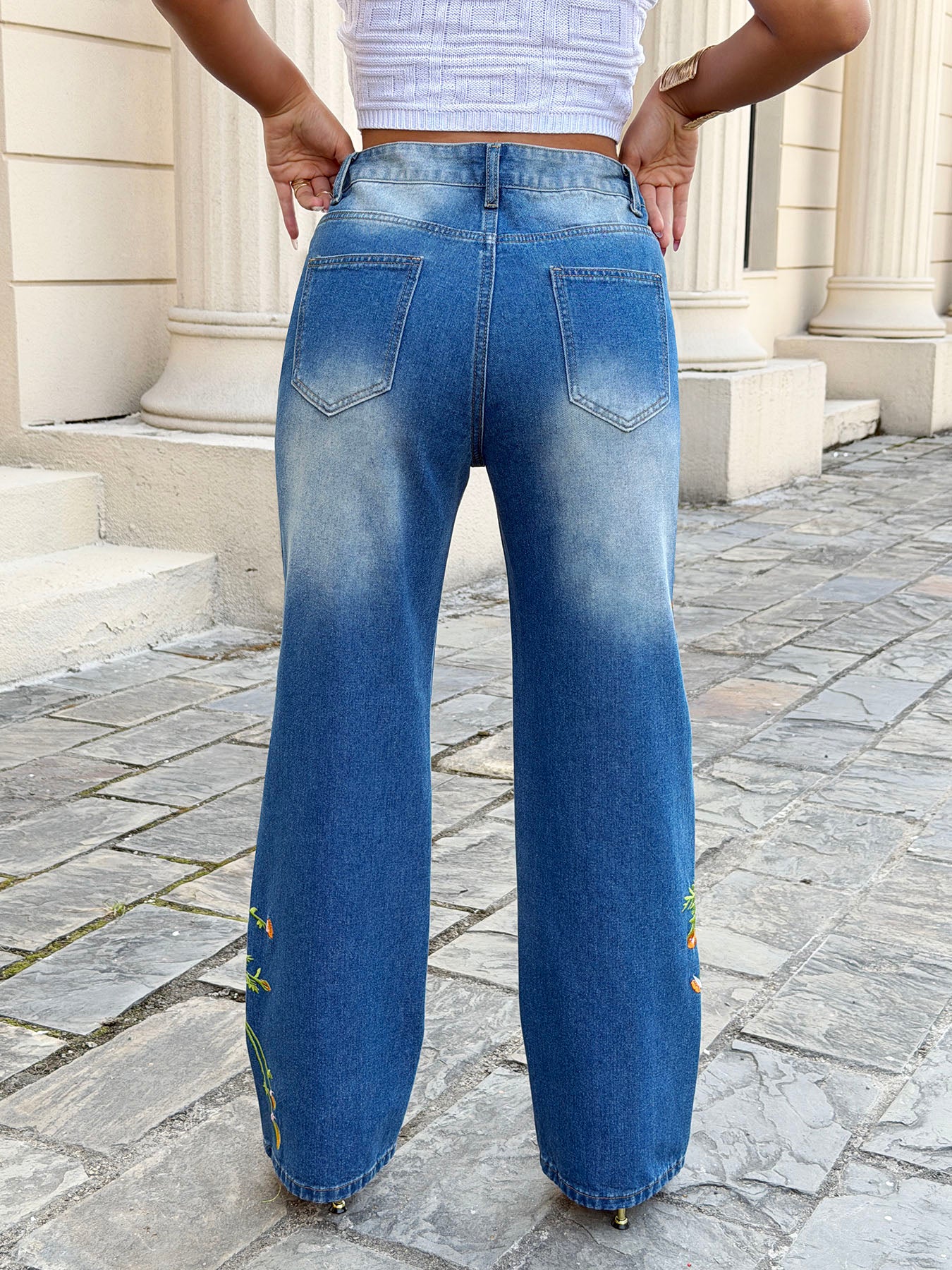 Styled vintage blue embroidered ripped jeans for women – loose straight leg casual denim pants with oversized tee and sneakers relaxed outfit look