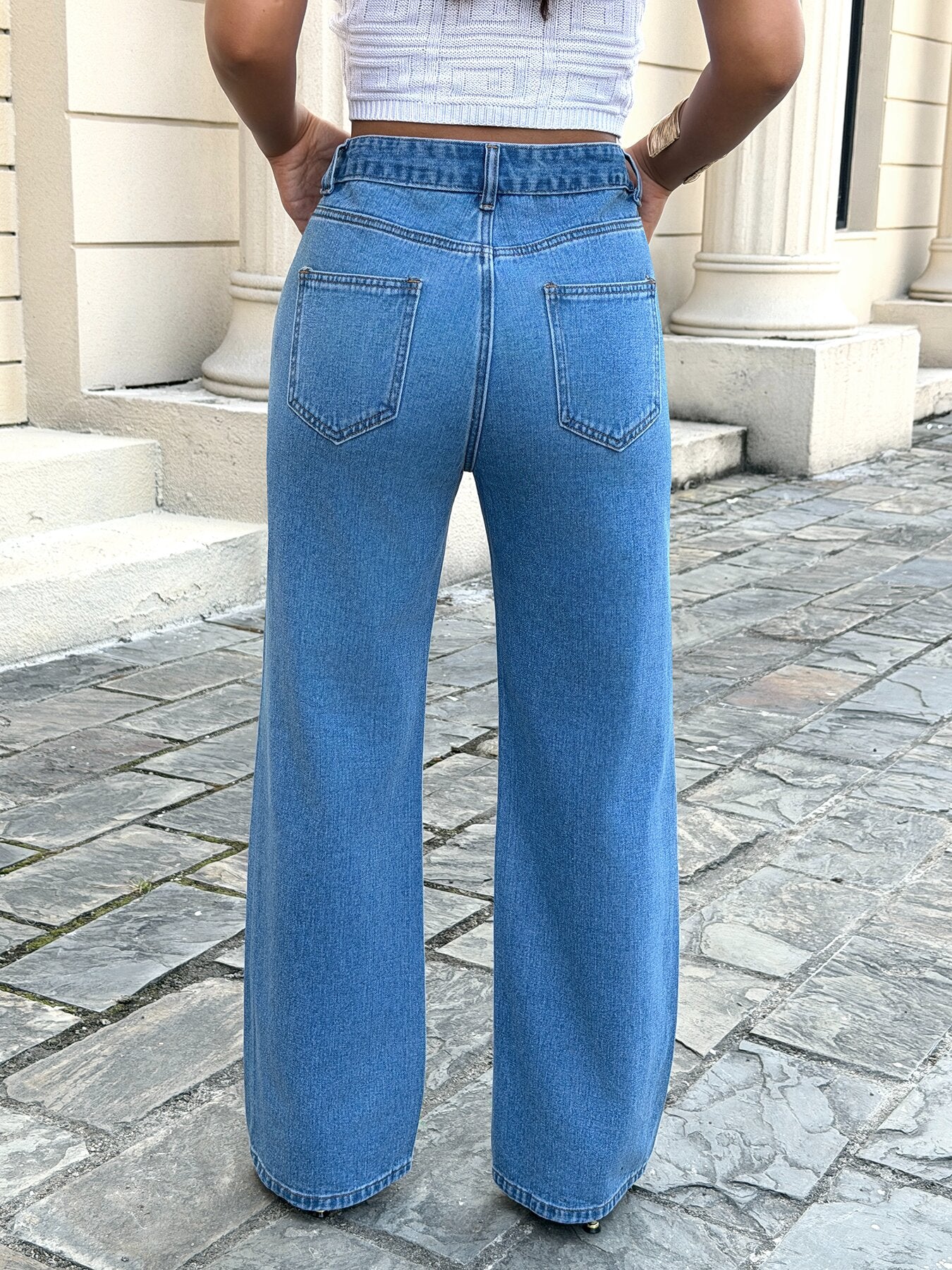 Wide leg jeans for women with embroidery – side view of classic blue loose fit straight leg denim pants on model showing flowy fit