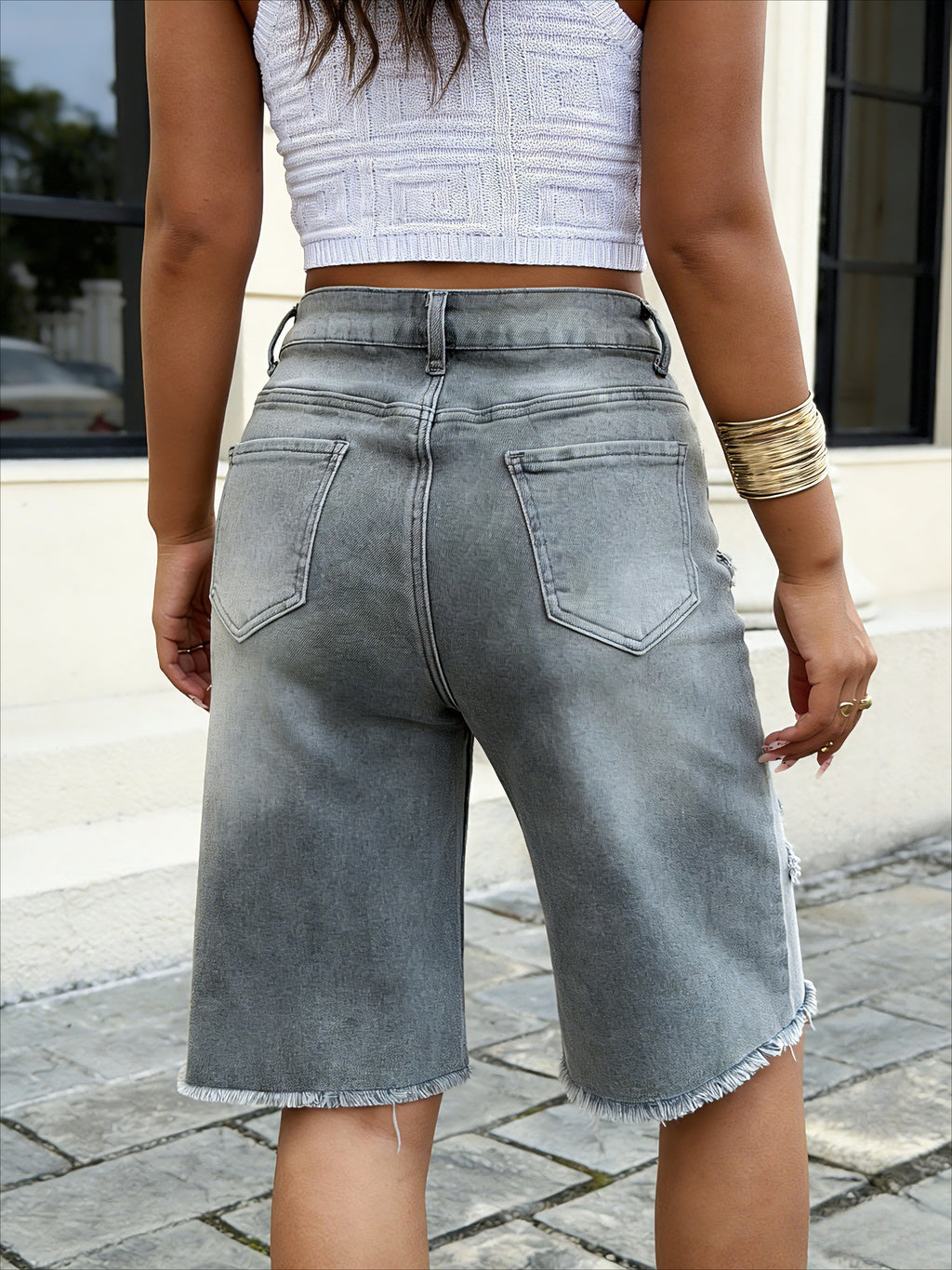 Wide leg grey denim shorts with raw hem – side view of stretchy classic jeans shorts showing relaxed fit on model